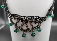 Elevate your gothic or Victorian-inspired ensemble with this stunning vintage-style lace choker.The delicate black lace serves as the perfect backdrop.  designed with an antique brass filigree, adorned with vibrant emerald green crystal beads that add a touch of elegance and mystery. This necklace can be for a special occasion or everyday wear. Size 30 and 31 centimeters with an extension chain of 7 centimeters Emerald Choker, Emerald Green Crystal, Brass Filigree, Lace Choker, Green Crystal, Choker Necklaces, Green Crystals, Vintage Stil, Emerald Green