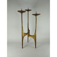 two brass candlesticks are standing next to each other