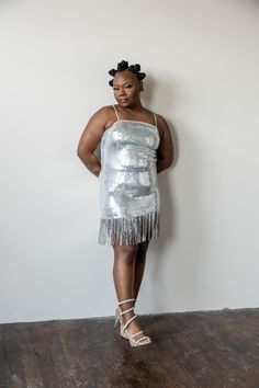 This Silver fringe dress will make you sparkle! Boasting silver sequins and beautiful fringe details, it’s perfect for any night out. Radiate elegance and light up the room in this beautiful dress. model 1 is wearing a large model 2 is wearing a small Sequin Mini Flapper Dress For Party Season, Glamorous Sleeveless Fringe Flapper Dress, Glamorous Mini Length Sequined Flapper Dress, Glamorous Beaded Fringe Dress For Date Night, Glamorous Fitted Sequin Dress With Beaded Fringe, Glamorous Fringe Dress For Date Night, Glamorous Sleeveless Fringe Mini Dress, Fringe Mini Flapper Dress For Parties, Beaded Fringe Dress For Party Season Night Out