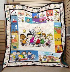 a quilt made to look like peanuts and the gang on it's front cover