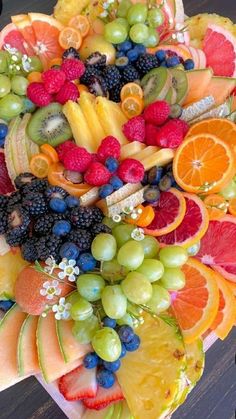 a platter filled with lots of different types of fruit