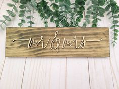 a wooden sign with the word mr and mrs written in cursive writing on it