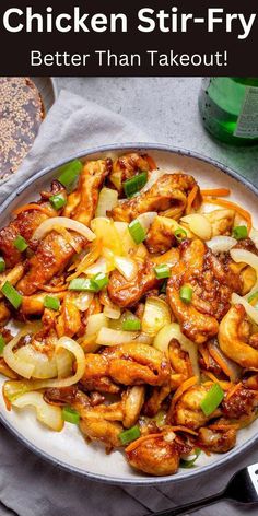 chicken stir fry in a pan with onions and green peppers