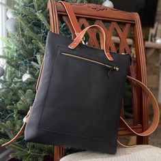 The Kodiac Leather Backpack - Tote in Black This beautiful full-grain Kodiac leather backpack /tote is perfect for everyday uses and for travelers. This soft and stylish backpack features veg-tanned straps and brass hardware and copper rivets. This bag is a convertible tote or backpack with an interior pocket and adjustable straps. This bag will fit laptops, books and more. Handcrafted in our North Carolina workshop of the finest full-grain leather, our bags are durable, as they are beautiful an Leather Shoulder Bag Backpack For On-the-go, Daily Use Leather Backpack With Leather Lining, Leather Backpack With Leather Lining For Daily Use, On-the-go Satchel With Leather Lining, Leather-lined Satchel Backpack For On-the-go, Everyday Leather Standard Backpack, Black Backpack With Leather Handles For On-the-go, Rectangular Backpack With Leather Lining For Everyday Use, Leather Backpack With Leather Handles For Everyday