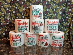 several rolls of toilet paper sitting on top of a counter next to each other with christmas designs