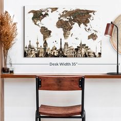 a desk with a wooden chair and a world map on the wall in front of it