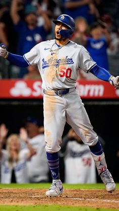 a baseball player with his arms out in celebration