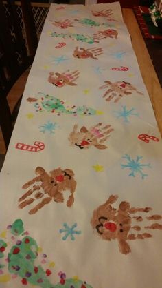 a table with handprints on it sitting next to a christmas tree