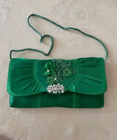 Beautiful purse for the bride's necessities, it has a silver metal chain; THIS LISTING IS ONLY FOR THE CLUTCH BAG, NOT THE SHOES, FOR SHOES SEE BELOW. Delicately adorned with a crystals brooch, and lace appliques: pearls crystals & sequins. Colors: Green, White, or Ivory Size: 8.25'' x 4'' To view, or to buy matching Wedge Wedding Shoes 1'' high: www.etsy.com/listing/152596956/wedding-wedge-shoes-crystals-lace-satin FINAL SALE, NO RETURNS, NO EXCHANGES! INTERNATIONAL ORDERS: The Buyer is respons Green Embellished Wedding Bag, Green Embellished Wedding Bags, Green Embellished Evening Bag For Wedding, Green Rectangular Evening Bag For Wedding, Silver Embellished Evening Bag For Wedding, Green Clutch Evening Bag For Wedding, Rectangular Satin Wedding Bag, Bridal Clutch Purse, Formal Clutch