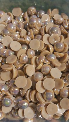 a bunch of brown and white buttons in a bowl