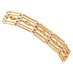 An exceptional, fine and impressive unusual 9 karat gold 5 bar gate bracelet; part of our diverse antique jewellery collections. This exceptional, fine and impressive antique bracelet has been crafted in 9k yellow gold. The gate style bracelet displays twelve interlocking links, each consisting of four horizontal bars and a central knot design; the additional ornamentation is unusual and desirable. These links conjoin and articulate via twelve groups of six oval links. The antique 1920s bracelet Luxury Handmade Antique Bracelets, Luxury Adjustable Antique Jewelry, Luxury Antique Adjustable Jewelry, Luxury Yellow Gold Bracelets With Sterling Silver Clasp, Luxury Handmade Antique Bracelet, Luxury Art Deco Yellow Gold Bracelets, Luxury Antique Gold Chain Bracelet, Luxury Antique Hinged Jewelry, Luxury Antique Hallmarked Gold Bracelet