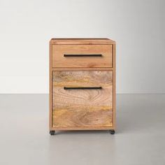 a wooden drawer with two drawers on wheels