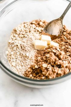 a glass bowl filled with oats and butter