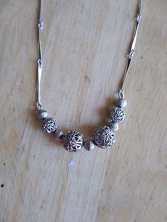 Silver tone necklace.  Great condition.  Necklace measures about 19". Beaded Metal Necklaces With Round Beads, Elegant Silver Dangling Beads, Elegant Metal Necklaces With Polished Beads, Elegant Silver Metal Bead Jewelry, Elegant Silver Metal Beads Jewelry, Vintage Metal Necklace With Dangling Beads, Vintage Metal Necklaces With Dangling Beads, Metal Beaded Chain Necklace For Gift, Silver Necklace With Spacer Beads