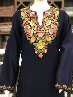 A stunningly marvellous Pheran. This Pheran features intricate Kashmir Aari embroidery on neckline and sleeves.- - - - - - - - - - - - - - - - - - - - Product Details- Condition: Brand New (made to order)- Style: Pheran Tunic- Fabric: Wool- Colour: Navy Blue- Embroidery: Aari Work- Embroidery Colour: Multi-Colour- Standard Length: 40" - Care Instructions: Dry Clean Only.**If you want the Tunic to be shorter or longer, just send us a message, and we will tailor it accordingly.Sizing- Please selec Kashmir Kurti Design, Phirans Kashmiri Style, Kashmiri Phiran, Kashmiri Kurta, Kashmiri Dress, Kashida Embroidery, Kashmiri Embroidery, Indian Kurta, Aari Embroidery