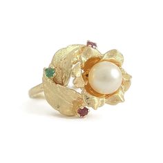 Vintage 1950's Pearl Ruby Emerald Cocktail Ring 14K Yellow Gold, 6.49 Grams This is such a lovely ring! Please let us know if you have any questions. Circa: 1950's Pearl: 1 round cultured pearl, 7.2 mm Gemstones: .09 ctw; 2 round rubies .06 ctw; one round green emerald .03 ct Metal: 14K yellow gold Weight: 6.49 grams Stamped: 14K Size: 8 (can be sized for a small fee) Width: 17.6 mm at top of ring; 1.4 mm at sides of band Condition: one ruby chipped Vintage White Pearl Ring Stamped 14k, Vintage Multi-stone Pearl Ring For Anniversary, Vintage White Pearl Ring, Vintage Multi-stone Pearl Ring For Formal Events, Vintage Multi-stone Pearl Ring For Formal Occasions, Vintage Pearl Ring For Gift, Emerald Cocktail Ring, Emerald Cocktail, Antique Jewelry Rings