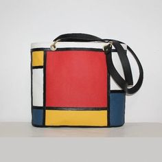 A stylish medium-sized leather tote bag with a geometric design inspired by the works of Piet Mondrian. -  The bag is made of excellent quality Italian leather, soft and pleasant to touch, it holds its shape perfectly. -  Zipper closure. -  Inside there is a zippered pocket and a double open pocket. -  The dimensions of the bag are 28 x 27 x 11 cm. (11'' x 10.6'' x 4.3'') Made in Italy. Impeccable artisanal work and magnificent design. And most importantly! This is not just a bag, it is a WORK O Modern Bucket Shoulder Bag For Gift, Modern Bucket Bag As Gift, Modern Square Bucket Bag, Modern Bucket Bag For Gifts, Modern Bucket Bag For Gift, Modern Red Box Bag With Large Capacity, Modern Square Bucket Bag As Gift, Modern Square Bucket Bag For Daily Use, Modern Red Tote Box Bag