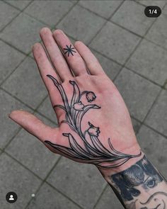 a person's hand with tattoos on it