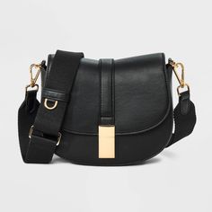 This Saddle Crossbody Bag from A New Day™ with a structured silhouette features a roomy main compartment and an interior zip pocket for easy organization of your belongings, plus an overlapping flap with a gold-tone buckle accent and magnetic closure. Plus, the detachable adjustable shoulder strap makes carrying a breeze whether you sling it over one shoulder or carry it in hand. A New Day™: Style that goes wherever you do. Target Purse, Saddle Crossbody Bag, Black Crossbody Purse, Top Handle Handbags, Crossbody Messenger Bag, Black Crossbody, Small Purse, Black Cross Body Bag, A New Day