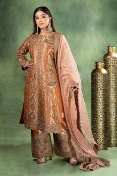 Golden brown full sleeves A-line kurta with all over mughal palazzo gul embroidery using dori, kiran and sequin highlights. Paired with a matching heavily embroidered flared palazzo and a baby pink floral cutwork border embroidered organza dupatta. - Aza Fashions Embroidered Anarkali Palazzo Set With Long Sleeves, Elegant Jamawar Palazzo Set For Wedding, Bollywood Style Embroidered Long Sleeve Palazzo Set, Long Sleeve Palazzo Set With Intricate Embroidery For Weddings, Anarkali Sharara With Intricate Embroidery And Long Sleeves, Anarkali Sharara With Intricate Embroidery, Anarkali Style Long Sleeve Palazzo Set For Festivals, Bollywood Style Semi-stitched Sets With Long Sleeves, Semi-stitched Long Sleeve Palazzo Set With Intricate Embroidery