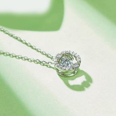 An eye-catching round moissanite dances with ease at the center of this appealing women's necklace, expressing your unstoppable love. Additional round gem set in sterling silver frame the center. Features Moissanite was originally found in meteorites(Chemical name: Silicon Carbide). It was first discovered in 1893, while a scientist was examining meteor samples from a crater in Arizona. After many years, the experts has been recreated moissanite in the laboratory, that make the gemstone with fri Round Halo Setting Necklace With Lab Grown Diamond, Round Lab Grown Diamond Necklace With Halo Setting, Round Necklace With Halo Setting And Lab Grown Diamond, Moissanite Necklace With Halo Design In Diamond White, Diamond White Round Pendant Jewelry With Center Stone, Diamond White Jewelry With Center Stone Round Pendant, White Gold Necklaces With Center Stone For Anniversary, Anniversary Necklace With Round Center Stone, Dazzling Solitaire Necklace With Round Pendant And Halo Setting