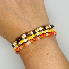 Add this stack bracelet to any combination to add a little Fall to your wardrobe. Choose from yellow, orange, or brown. Only available in Medium. Medium - The medium bracelet, 7.25", fits most adult women's wrists. NOTE: The best way to keep a stretch bracelet in good shape is to roll the bracelet on and off your hand and wrist. Continuously pulling it wider to put on your wrist will lead to overstretching and possibly breakage. Orange Stackable Bracelets With Round Beads, Stackable Orange Round Beaded Bracelets, Adjustable Orange Stackable Beaded Bracelets, Adjustable Stackable Orange Beaded Bracelets, Brown Stackable Beaded Bracelets Gift, Gift Stackable Brown Beaded Bracelets, Gift Brown Stackable Beaded Bracelets, Yellow Stackable Beaded Bracelets, Orange Stackable Beaded Bracelets For Gifts