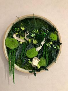 a bowl filled with lots of green plants