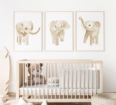 a baby's room with three pictures on the wall and a crib in front of it