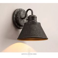 an old fashioned wall light is hanging on the wall