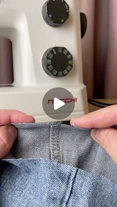 someone is sewing on the jeans in front of a sewing machine