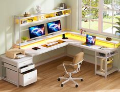 a computer desk with two computers on it