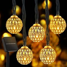 string lights with gold balls hanging from them