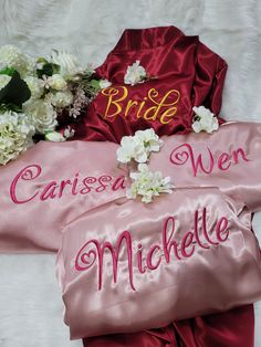 two bride robes and flowers on a bed