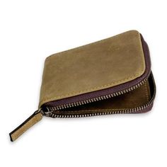 A zipper closure safeguards this wallet by Ricardo Hinojosa. Fully lined it opens to reveal a pocket for bills and six credit card compartments three on each side. It is handcrafted of amber leather.