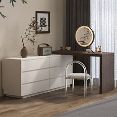 a white dresser sitting next to a wooden table with a mirror on top of it