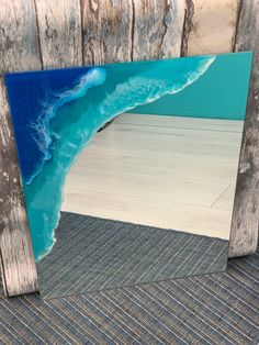 a wooden frame with an ocean scene painted on it