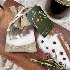 a wooden cutting board topped with spices next to a jar of honey and cinnamons