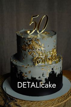 a 50th birthday cake decorated with gold and black icing