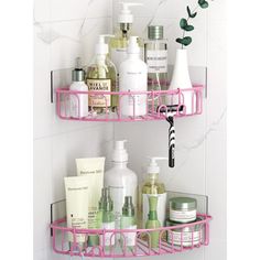 two pink shelves with soaps, lotions and other items on them in a bathroom