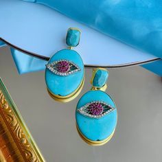 This stud earring has a turquoise stone stud and an oval shaped turquoise stone on which a beautiful eye shaped white and red zircons are studded all in brass metal with 18K gold plating. It's a perfect go to earring which suits with any outfit whether it is traditional or indo-western or western outfit. This is all handmade earring Turquoise Oval Earrings With Natural Stones, Oval Stone Earrings Gift, Oval Stone Earrings For Gift, Turquoise Earring, Western Outfit, Handmade Earring, Beautiful Eye, Stone Studs, Indo Western