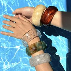 Step into summer with our Statement Vintage Chunky Bangles! Crafted from colourful irregular acrylic resin, each bangle is a unique geometric masterpiece, reminiscent of retro charm. The tortoiseshell design adds a touch of timeless elegance, perfect for those sunny summer days. Whether you're lounging by the pool or strolling along the beach, these bracelets are the ultimate accessory for adding a pop of colour to any outfit. Embrace your individuality and elevate your style with our vibrant an Trendy Plastic Bangle Bracelets, Trendy Plastic Bangle Jewelry, Trendy Adjustable Resin Jewelry, Trendy Summer Plastic Jewelry, Plastic Jewelry For Summer Beach, Resin Bracelets As Gifts, Trendy Clear Resin Jewelry, Green Plastic Summer Jewelry, Summer Party Clear Jewelry