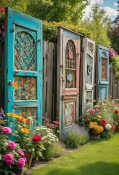 an outdoor garden with colorful flowers and wooden doors