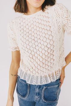 This vintage ivory top is a must-have with its crochet design, ruffle hem, and elegant mesh netting adorned with a delicate floral pattern and eyelets. Perfect for a stylish look that will turn heads. Details Crochet top Ruffle hem (mesh with eyelets) Short sleeves Mesh net with floral pattern and eyelets at sleeves, up the chest & back, and at hem Loose knit Ivory color Sizing Approximate measurements: SIZE LENGTH BUST Small 22" 36" Medium 22.5" 38" Large 23" 39" Fabric has some stretchModel is 5’8” wearing small Material 40% Acrylic 60% PolyesterHand wash coldDo not bleachLine dryIron low heat Eyelet Shorts, Mesh Netting, Ivory Tops, Crochet Design, Loose Knit, Top Sales, Ivory Color, Crochet Designs, Need You