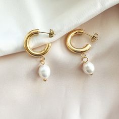 Pearl Perfection, in these contemporary yet classic white pearl dotted hoop earrings. Details:• Rhodium Plated or 18k Gold Plated Sterling Silver• White Freshwater Pearl• Size: 28mm • Post Earring White Pearl Charm Hoop Earrings, White Pearl Hoop Earrings With Pearl Charm, Everyday Round Hoop Earrings With Pearl Chain, Modern Hoop Earrings With Pearl Charm, White Hoop Pearl Chain Jewelry, Everyday Pearl Chain Hoop Earrings, White Pearl Drop Hoop Earrings, Modern Pearl Hoop Earrings For Wedding, Modern White Pearl Hoop Earrings