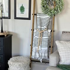 a living room filled with furniture and pictures hanging on the wall next to a ladder