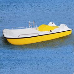 a yellow and white boat floating in the water