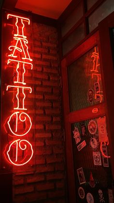 a red neon sign that is on the side of a building