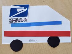 a mail truck made out of paper with the letter e on it's side