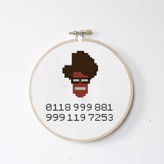 a cross stitch pattern with an image of a man's face on the front