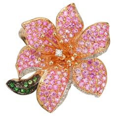 Spectacular Sapphire, diamond and Tsavorite Garnet flower cocktail ring. This stunning show piece is composed of 18k rose gold, 161 round pink sapphires, 31 round brilliant cut diamonds, and 11 round tsavorite green garnets crafted by an Italian designer. The total carat weight of all gemstones is 4.00cts. This ring is intricate, well crafted, and contemporary. It has a beautiful contrast combining the different colored stones set into a deep rose gold setting while being shaped into a blooming Luxury Brilliant Cut Flower Ring, Luxury Gemstone Rings In Flower Shape, Rose Gold Flower Ring, Show Piece, Gold Flower Ring, Rose Gold Flower, Tsavorite Garnet, Jewelry Words, Green Garnet